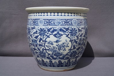 A Chinese blue and white fish bowl and a famille rose 'dragon' jardini&egrave;re, 19th C. and Yongzheng